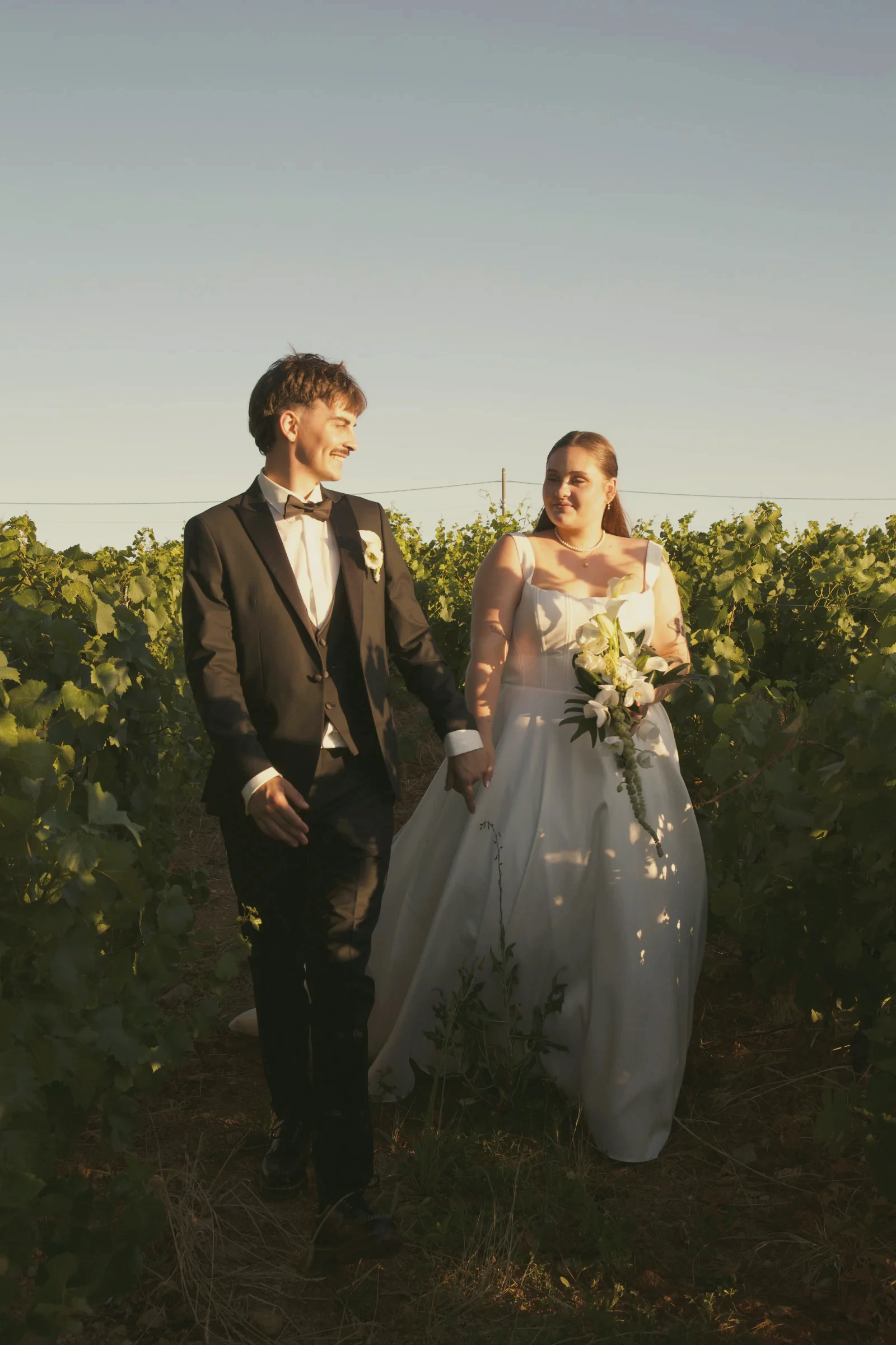 Portrait des mariés au milieu des vignes en fin de journée